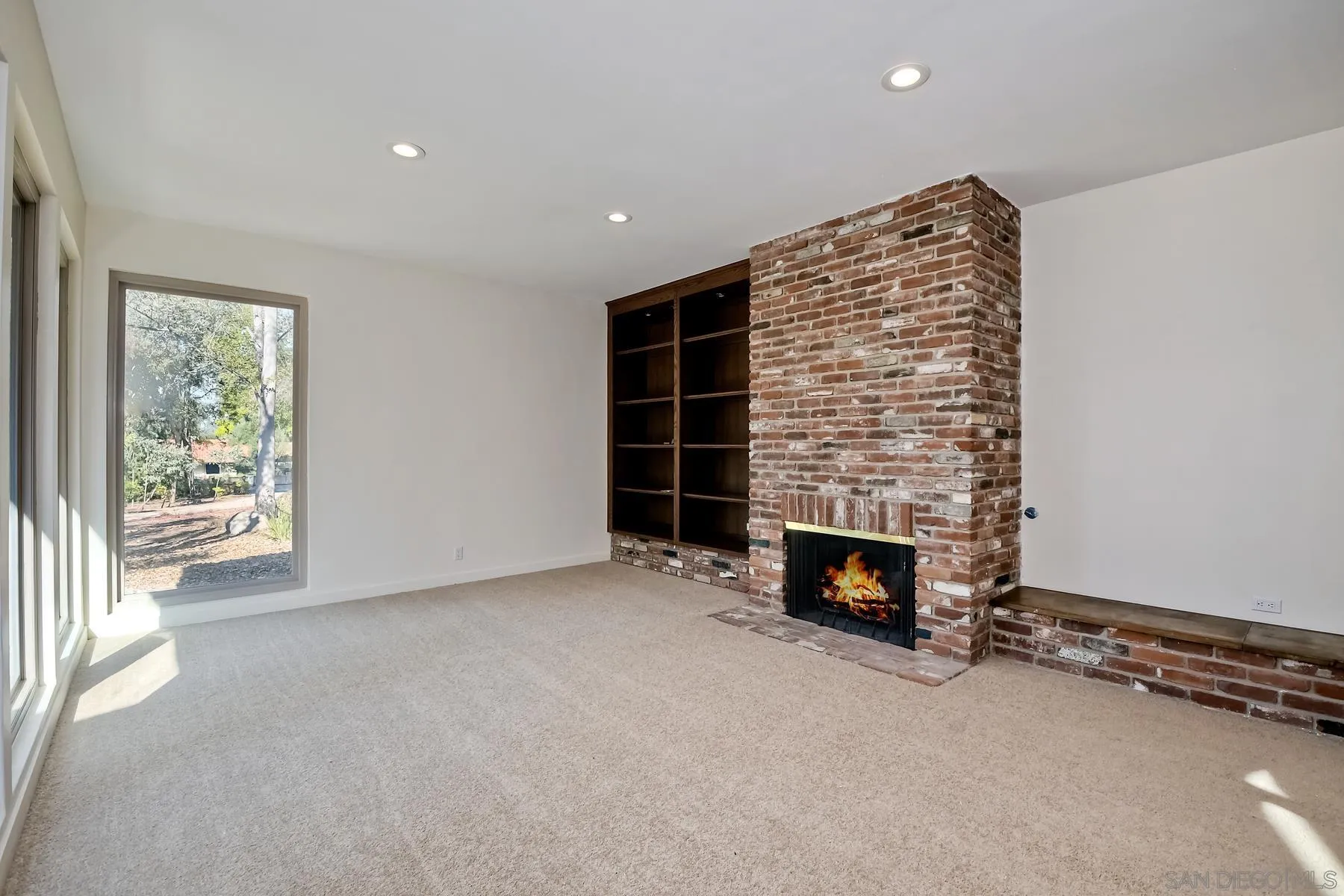 13541 Willow Run Road Poway, CA 92064 - Photo 3 of 40 an empty room with a fireplace and window