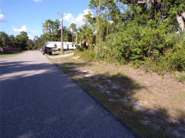 a view of a yard with cars parked