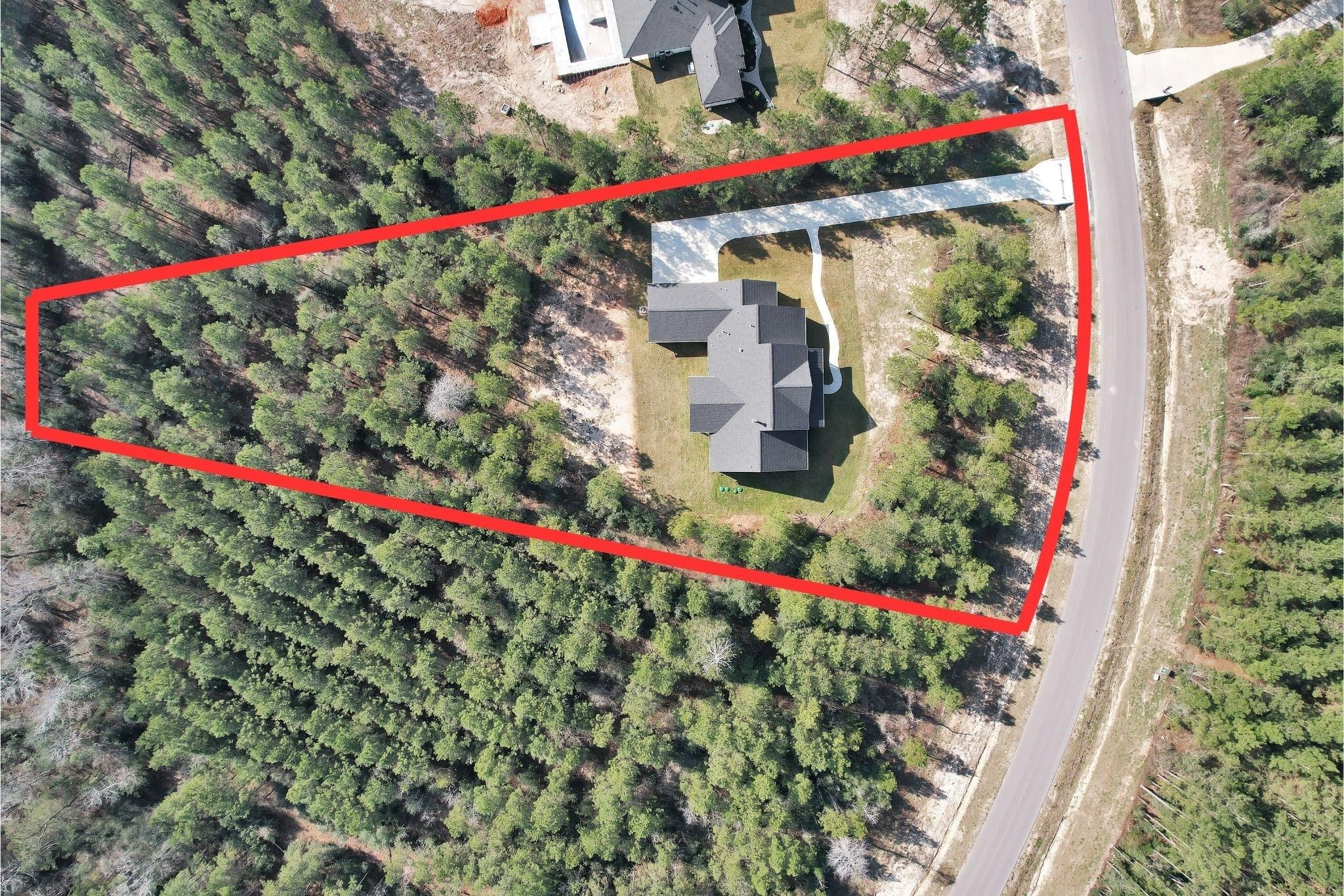 12744 Oak Barrel Road Willis, TX 77378 - Photo 32 of 38 Set on an impressive 1.65-acre homesite, this property offers an abundance of space, privacy, and natural beauty. Mature trees surround the home, creating a peaceful setting while still providing open areas to enjoy outdoor living.