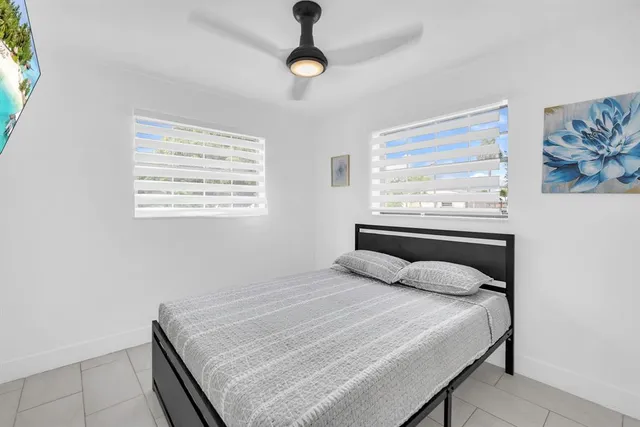 a bedroom with a bed and a painting on the wall