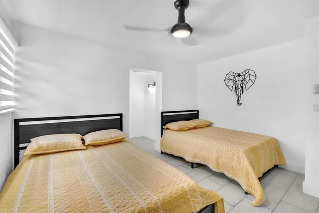 a bedroom with a bed and painting on the wall