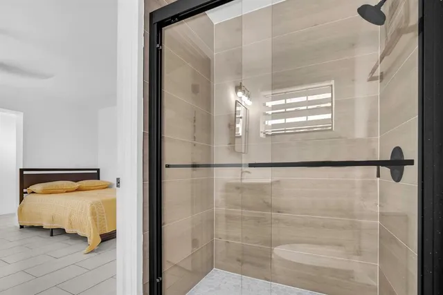 a bathroom with a sink mirror toilet and shower