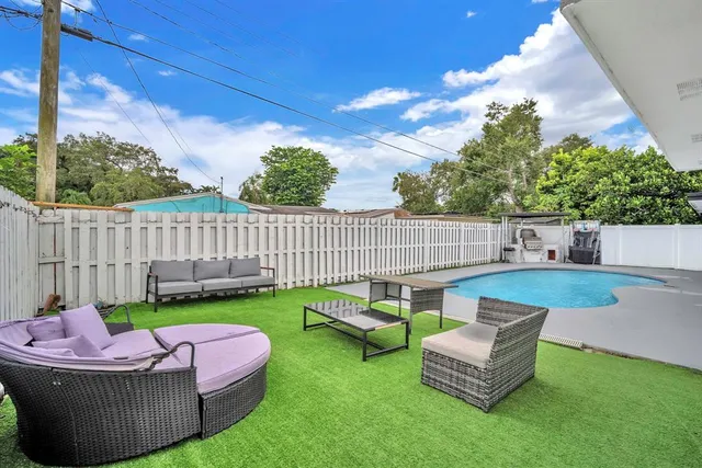 a backyard of a house with table and chairs