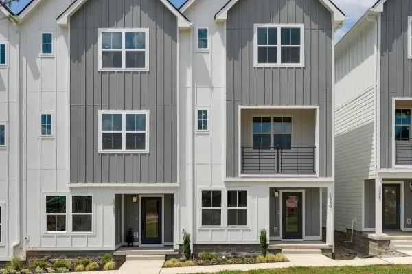 a kitchen with stainless steel appliances granite countertop a sink a stove a refrigerator and island with wooden floor