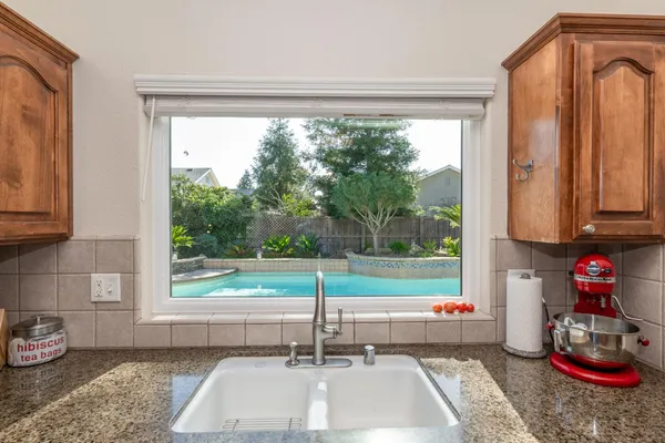 a kitchen with a sink and a large window