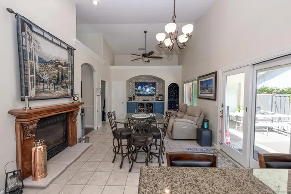 a living room with furniture a chandelier and a fireplace