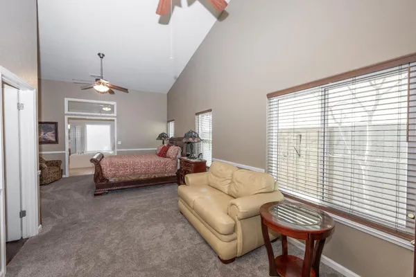 a bedroom with furniture and a chandelier