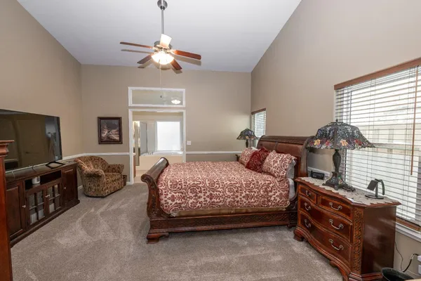 a bedroom with a bed and a chandelier
