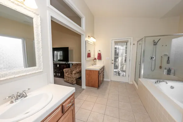 a bathroom with a bathtub sink and mirror