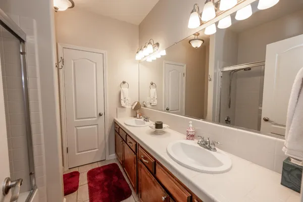 a bathroom with a double vanity sink and a mirror