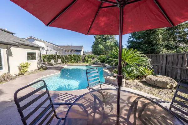 a view of a chairs and table in the patio