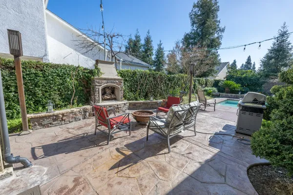 a view of a patio with table and chairs potted plants with wooden floor