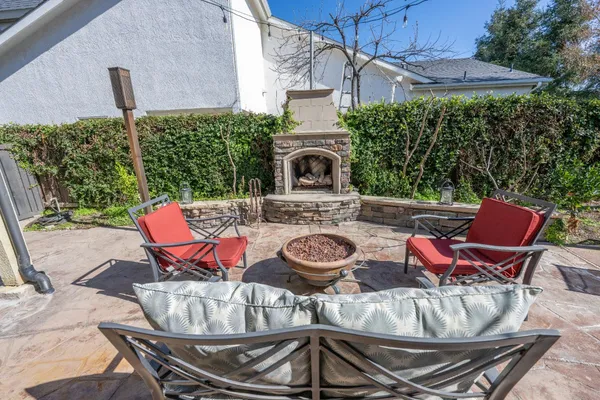 a view of a patio with table and chairs under an umbrella