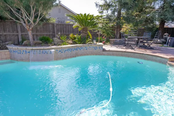 a view of a swimming pool with a patio