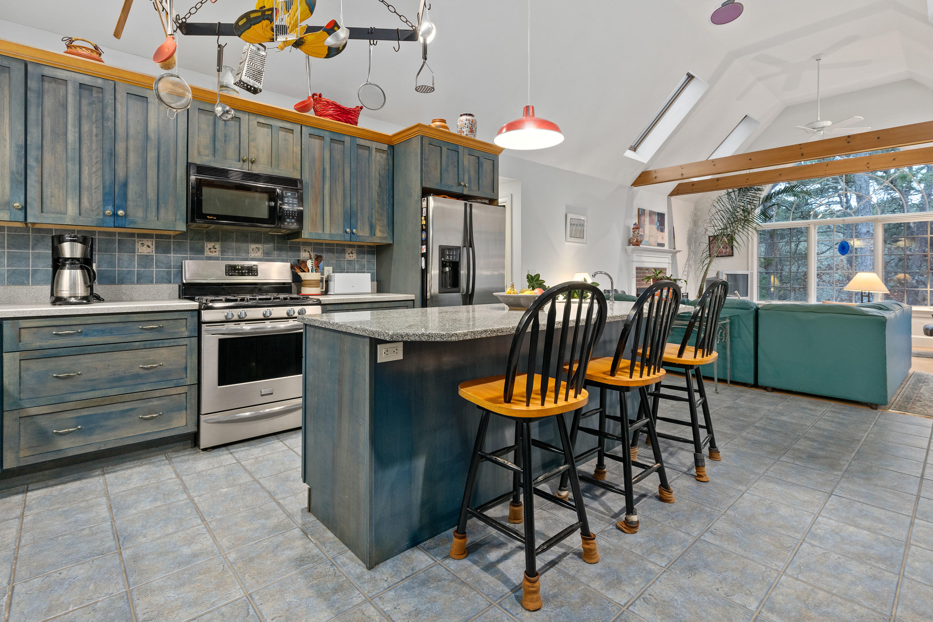 3 Parsons Path Harwich, MA 02645 - Photo 8 of 62 a kitchen with stainless steel appliances granite countertop a stove top oven a sink dishwasher a dining table and chairs with wooden floor