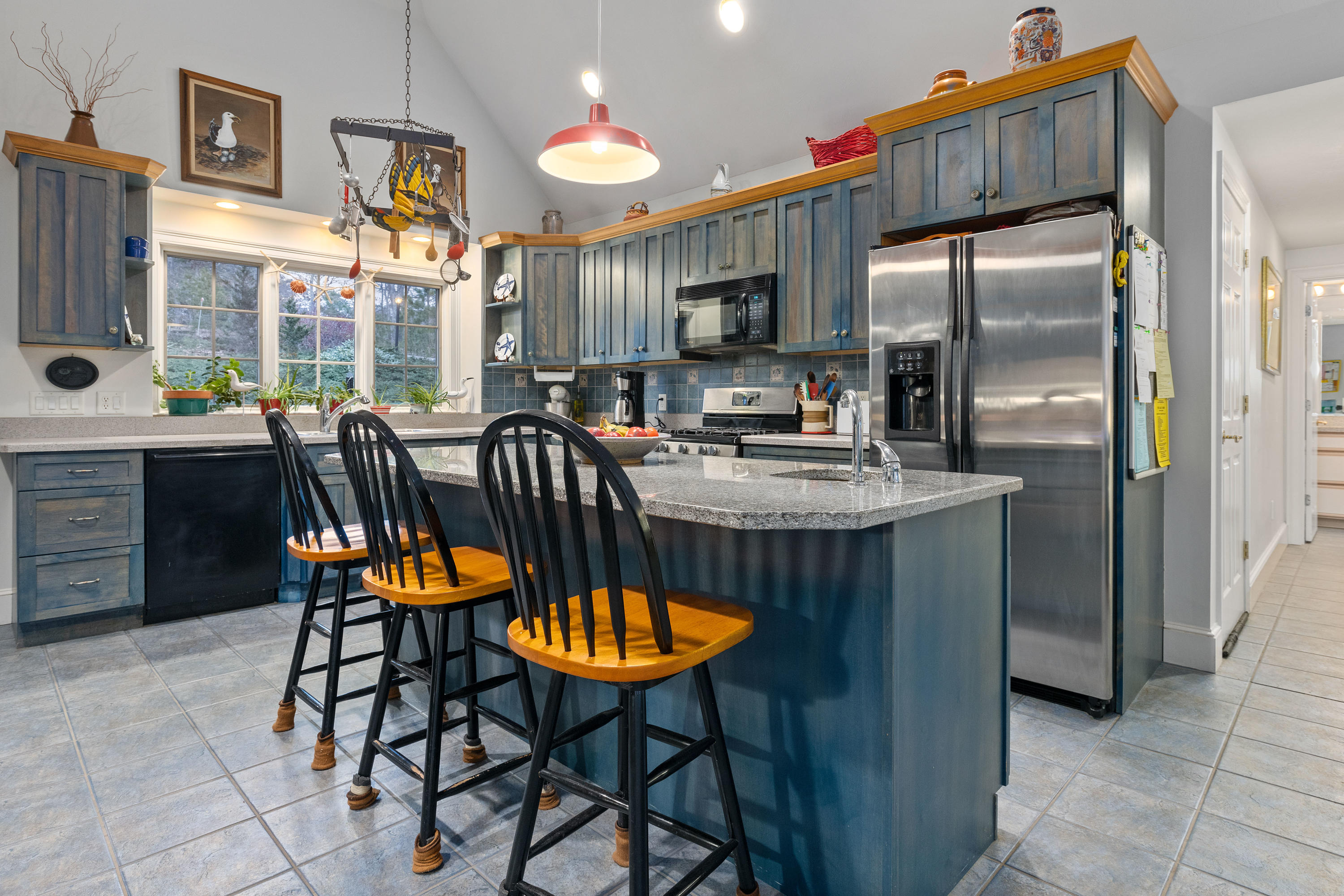 3 Parsons Path Harwich, MA 02645 - Photo 9 of 62 a kitchen with stainless steel appliances granite countertop a kitchen island a table and chairs in it