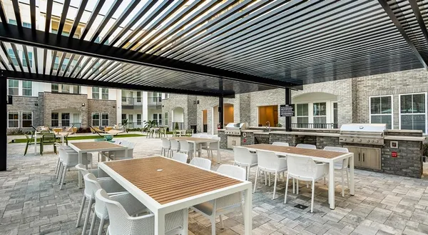 a outdoor space with lots of tables a chair and plants