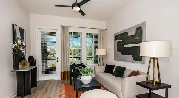 a living room with furniture and a wooden floor