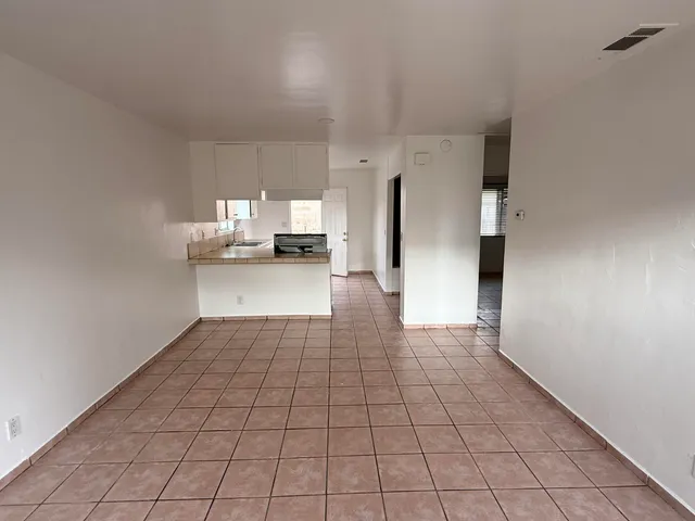 a view of a kitchen with a sink and dishwasher cabinets