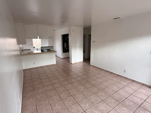 a large white kitchen with a sink and cabinets