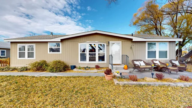 a front view of a house with outdoor seating