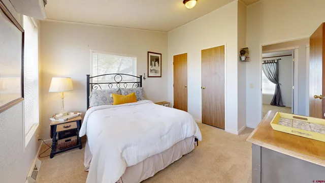 a bedroom with a bed and a lamp