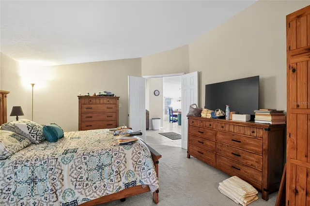 a bedroom with a bed and a television