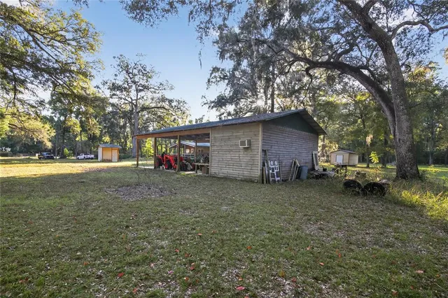 a view of a house with yard and tree s