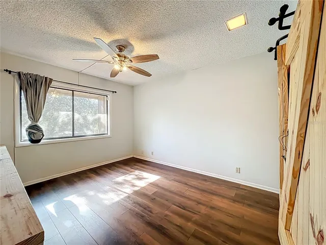 an aerial view of residential houses with outdoor space and trees