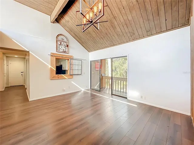 a view of a room with wooden floor and windows