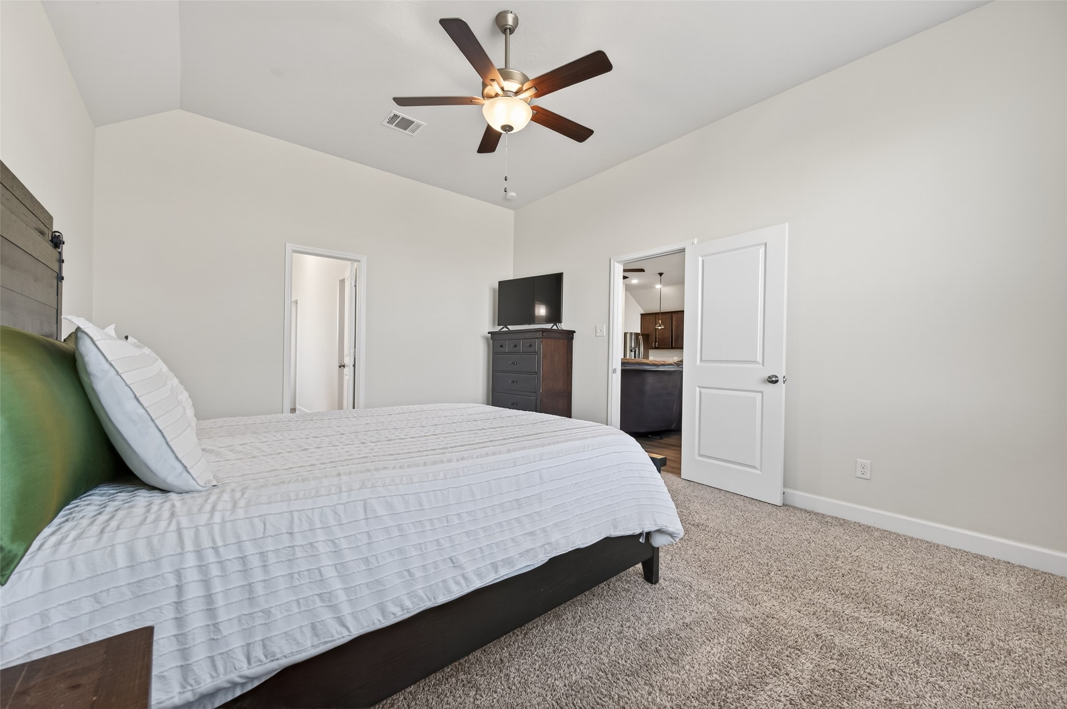 917 Farm Path Brenham, TX 77833 - Photo 22 of 43 a bedroom with a bed and a ceiling fan