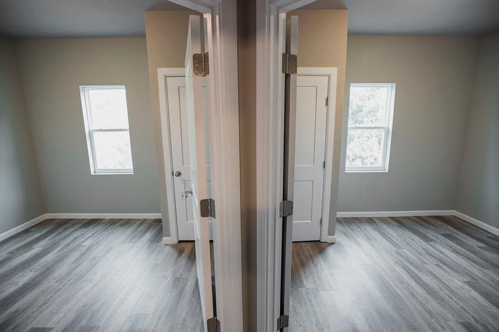 911 West 22nd Street, Unit 303 Austin, TX 78705 - Photo 12 of 23 an empty room with wooden floor and windows