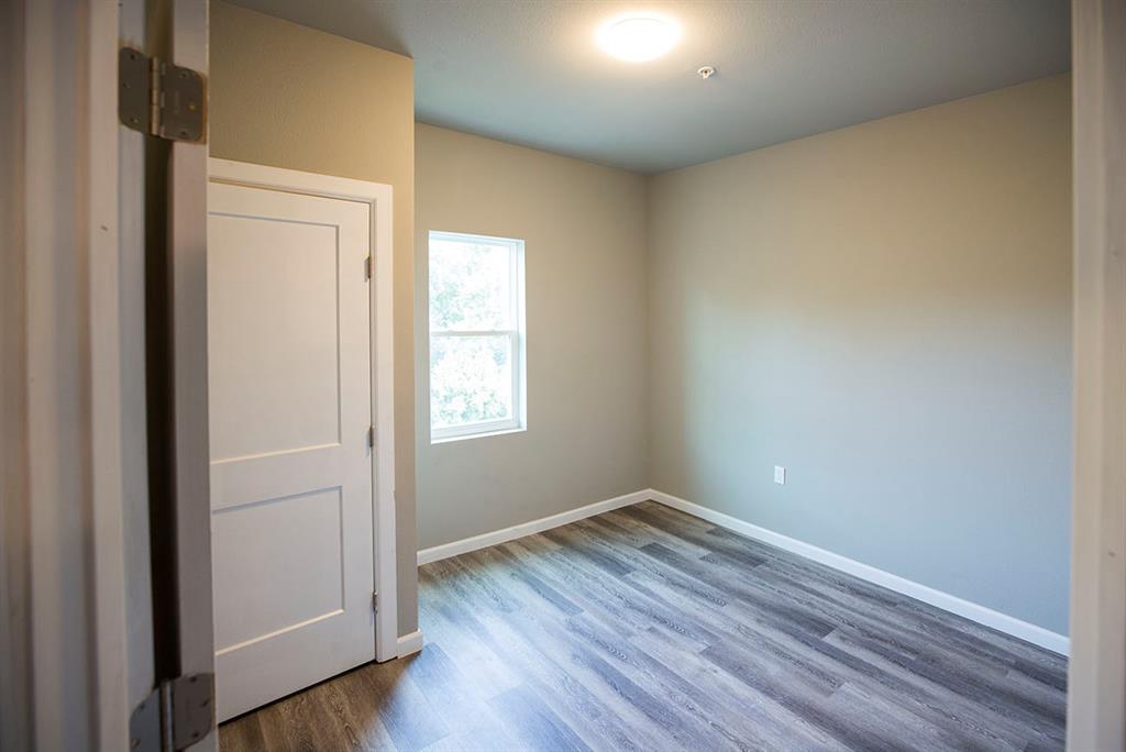 911 West 22nd Street, Unit 303 Austin, TX 78705 - Photo 13 of 23 an empty room with wooden floor and windows