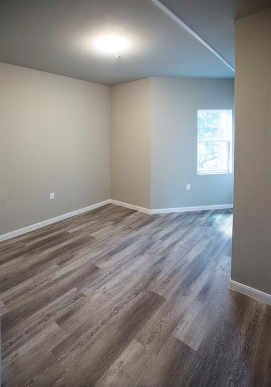 911 West 22nd Street, Unit 303 Austin, TX 78705 - Photo 15 of 23 an empty room with wooden floor and windows