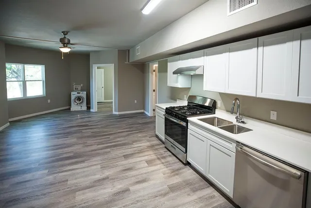 a kitchen with a sink and cabinets