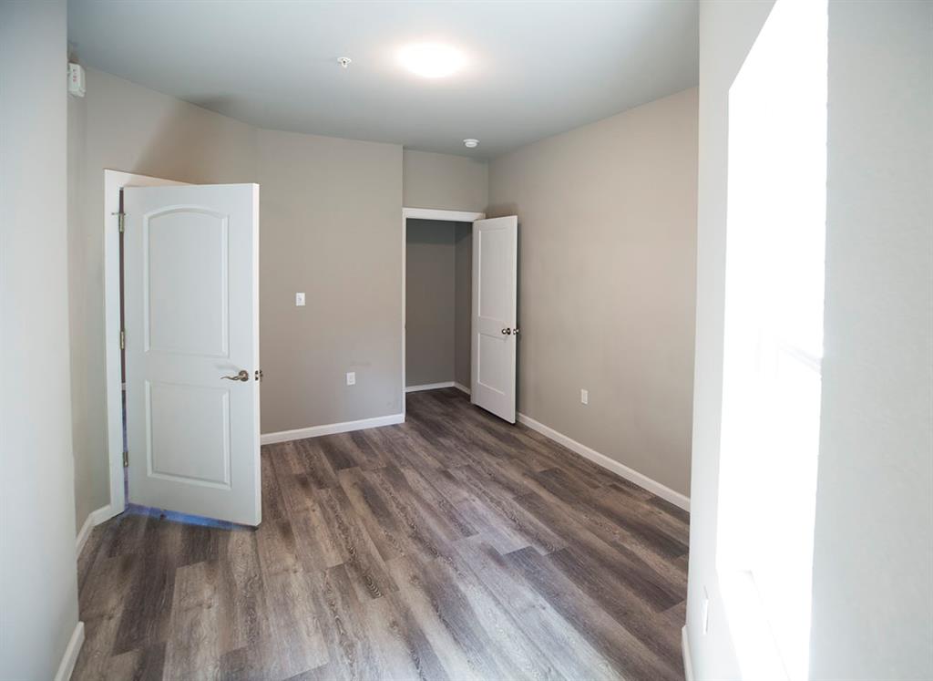 911 West 22nd Street, Unit 303 Austin, TX 78705 - Photo 21 of 23 a view of a hallway with wooden floor