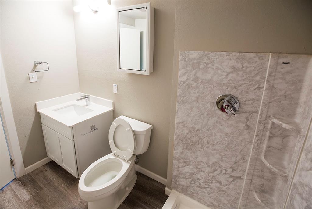 911 West 22nd Street, Unit 303 Austin, TX 78705 - Photo 23 of 23 a white toilet sitting next to a bathroom sink