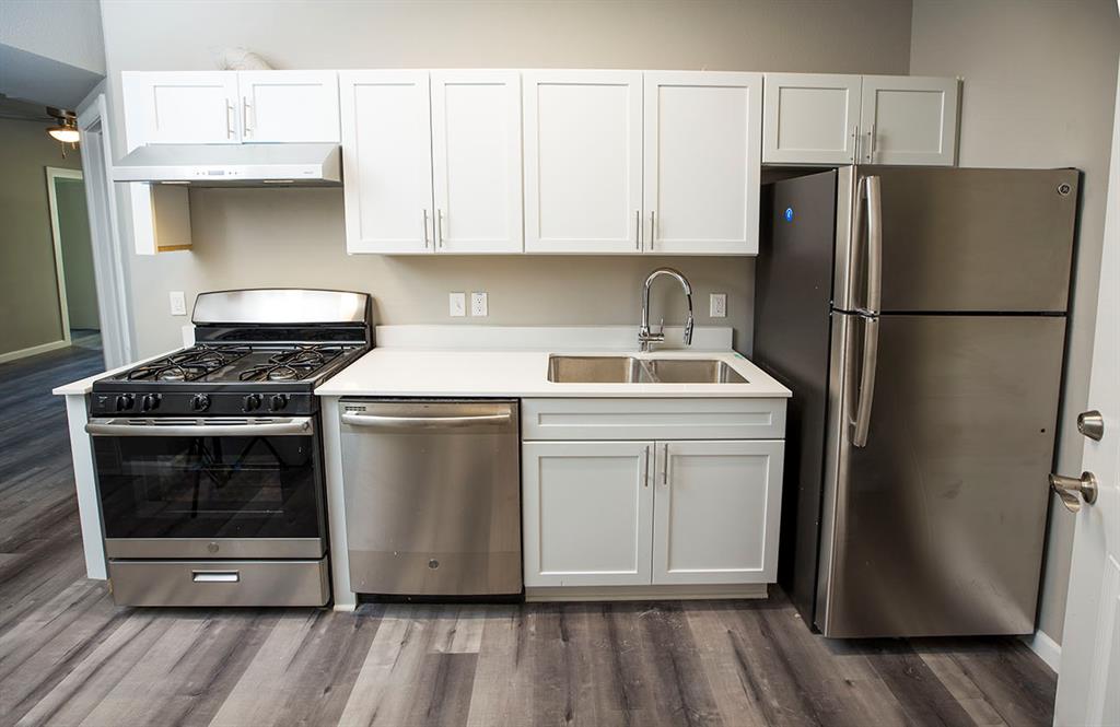 911 West 22nd Street, Unit 303 Austin, TX 78705 - Photo 9 of 23 a kitchen with a white stove top oven and refrigerator