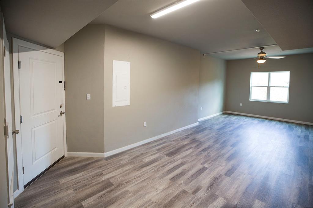 911 West 22nd Street, Unit 303 Austin, TX 78705 - Photo 10 of 23 an empty room with wooden floor and windows
