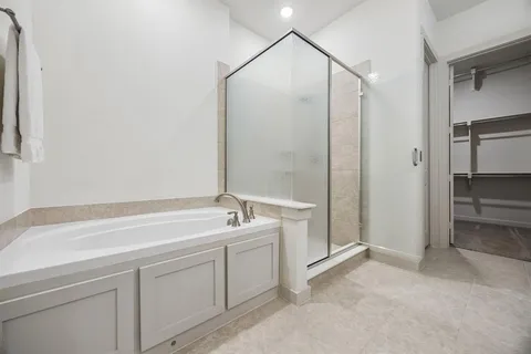 a spacious bathroom with a shower and a sink