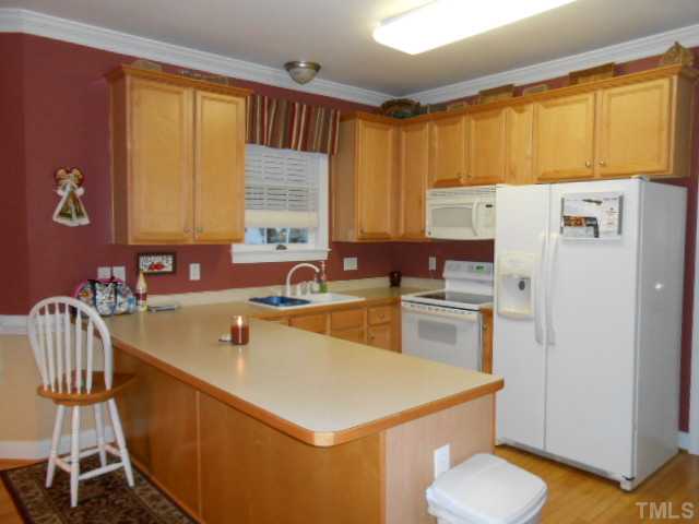 228 Sandstone Road Henderson, NC 27537 - Photo 4 of 25 Kitchen with pantry, electric range, dishwasher and microwave.