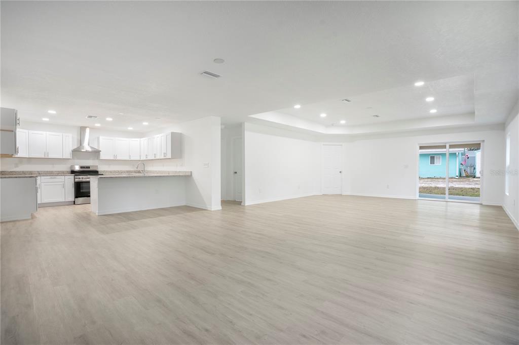 8448 Balm Street Weeki Wachee, FL 34607 - Photo 11 of 44 a view of a kitchen with a sink and a stove top oven