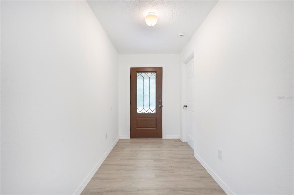 8448 Balm Street Weeki Wachee, FL 34607 - Photo 4 of 44 a view of hallway with wooden floor