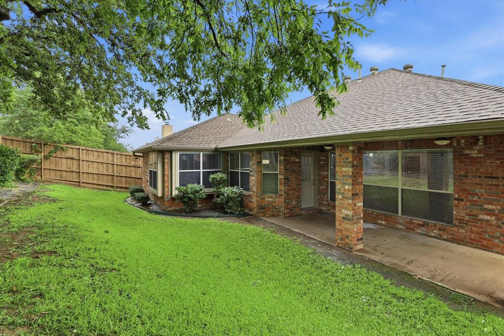 2616 Hollow Ridge Drive Denton, TX 76210 - Photo 31 of 31 Brick exterior with a covered patio and bay windows