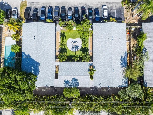 an aerial view of house with yard swimming pool and outdoor seating