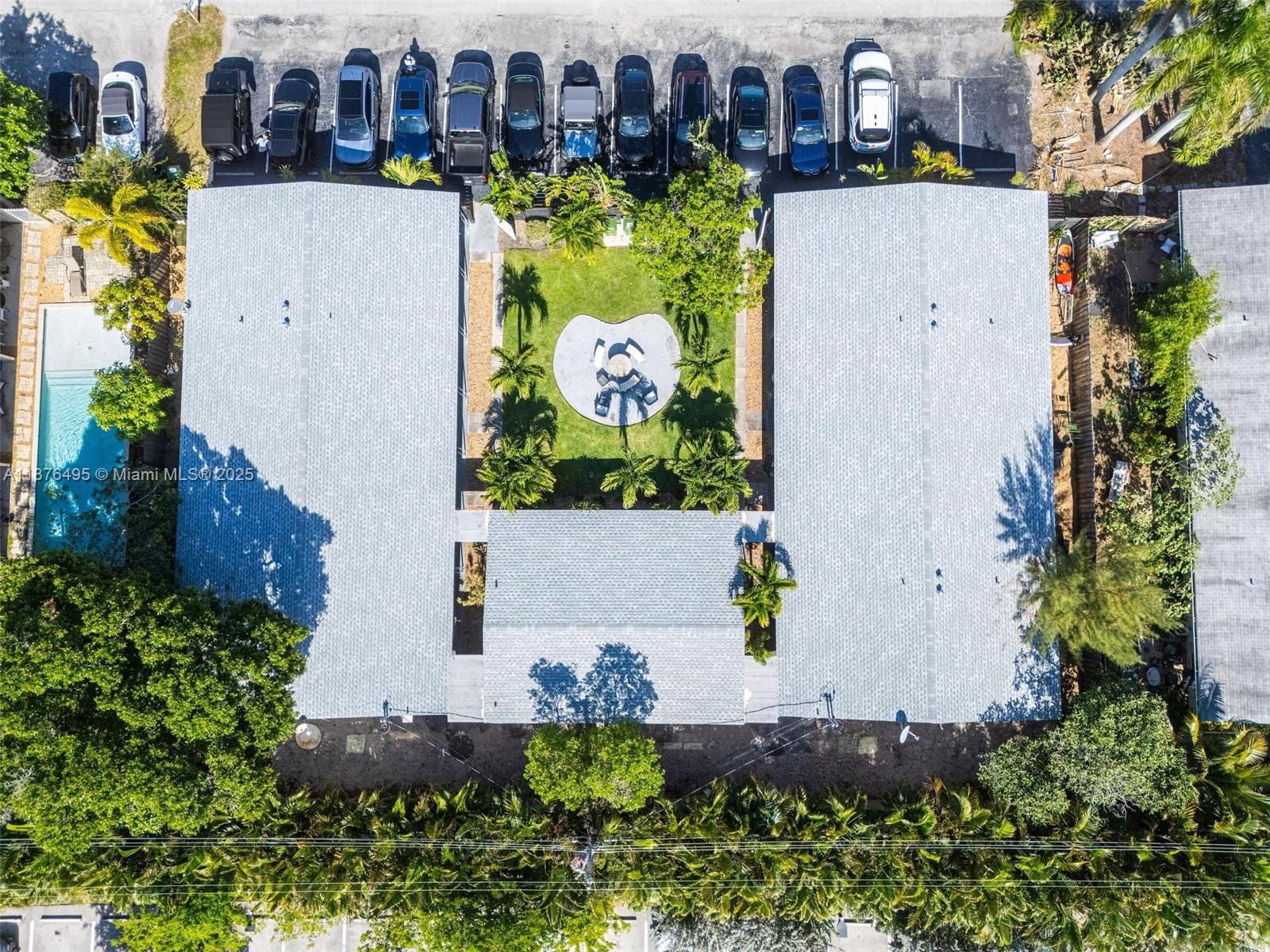 2201 Northeast 14th Avenue, Unit 9 Wilton Manors, FL 33305 - Photo 1 of 30 an aerial view of house with yard swimming pool and outdoor seating
