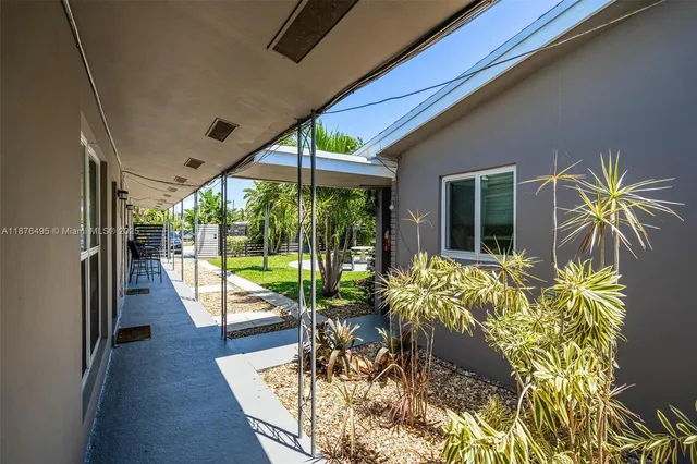 a view of a house with a yard and sitting area