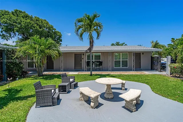 a kitchen with stainless steel appliances granite countertop a refrigerator stove a sink and a microwave