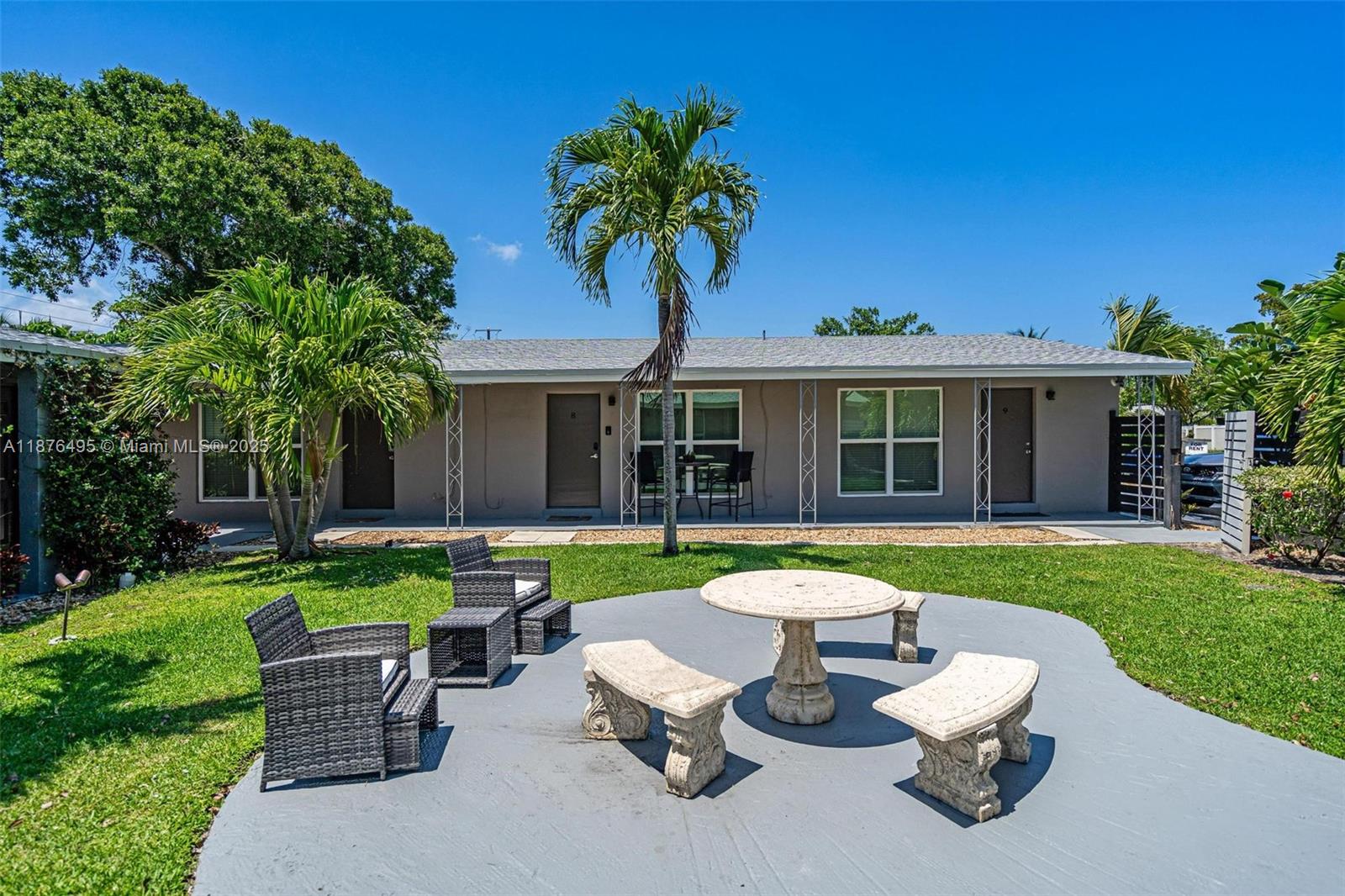 2201 Northeast 14th Avenue, Unit 9 Wilton Manors, FL 33305 - Photo 21 of 30 a view of a house with a yard and sitting area