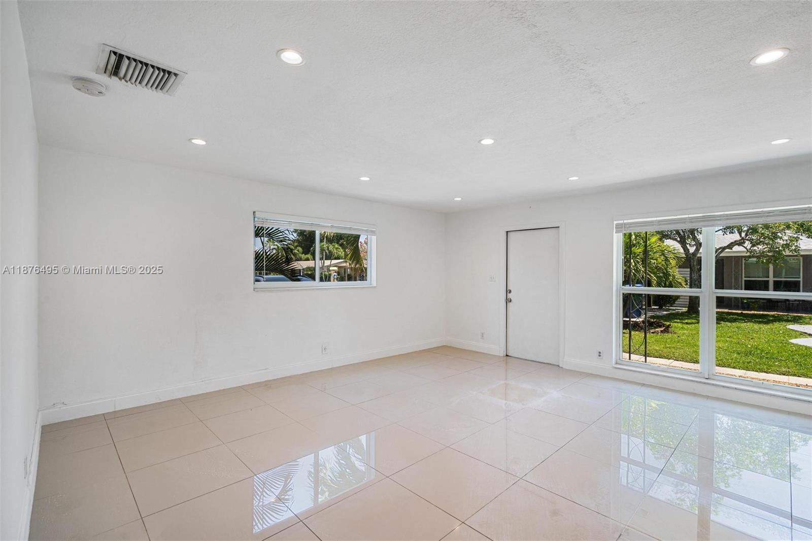 2201 Northeast 14th Avenue, Unit 9 Wilton Manors, FL 33305 - Photo 27 of 30 a view of an empty room with a window